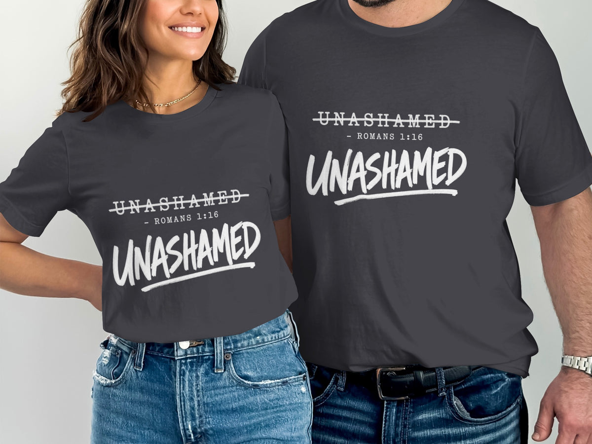 Two people wear dark grey t-shirts with white text that reads "UNASHAMED - ROMANS 1:16".
