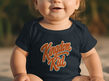 Baby in dark blue onesie with "Kingdom Kid" text.
