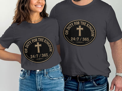 Dark grey t-shirts with a circular emblem featuring a cross and text.
