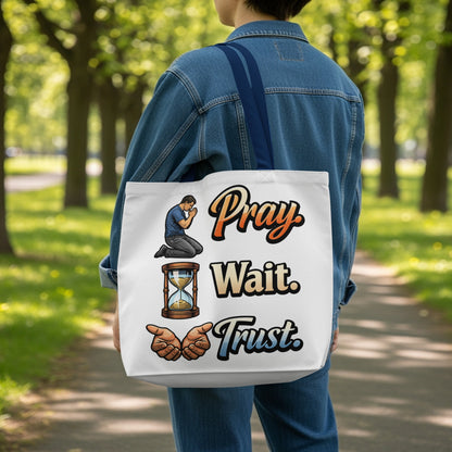 Tote bag with "Pray. Wait. Trust." text, hourglass, and praying hands illustration.