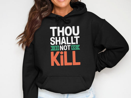 Black hoodie with white text "THOU SHALT NOT KILL" in stylized font.