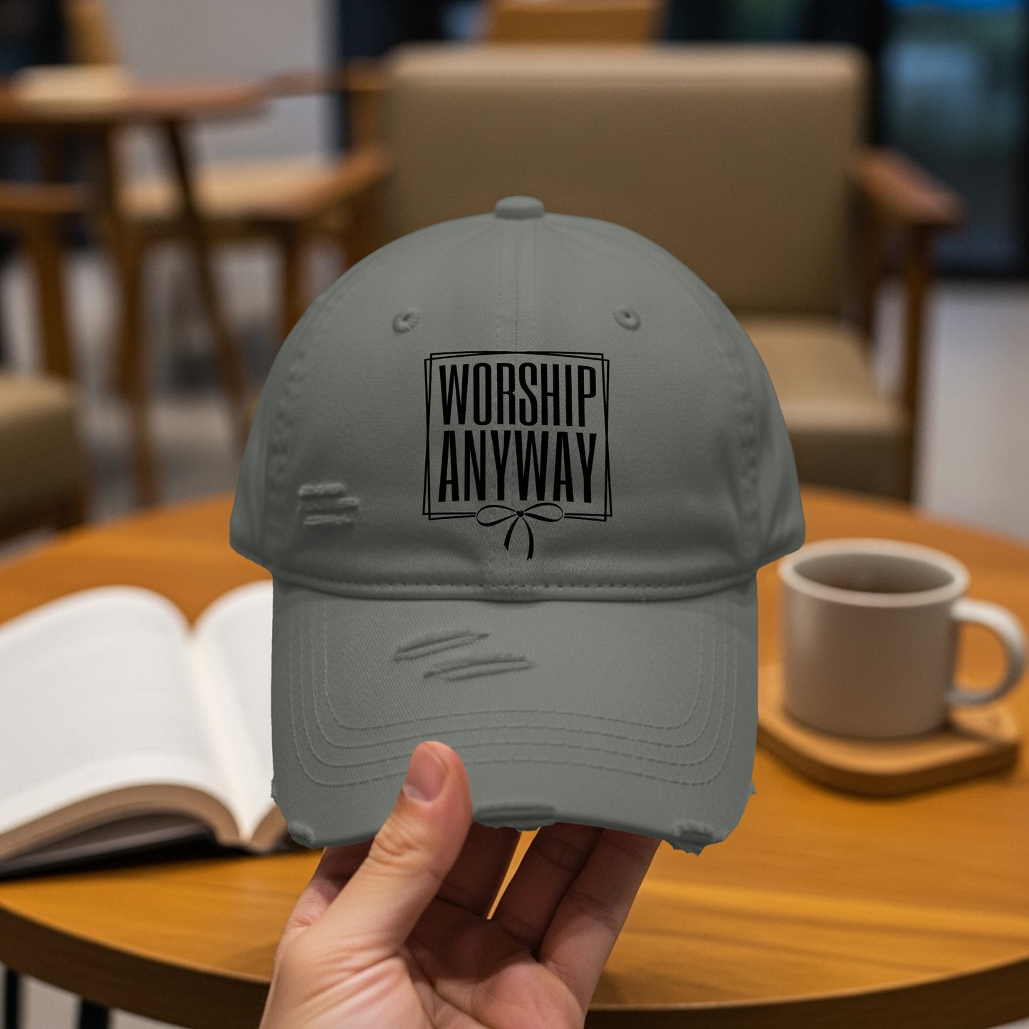 Distressed grey cap with "WORSHIP ANYWAY" text in black box on front.