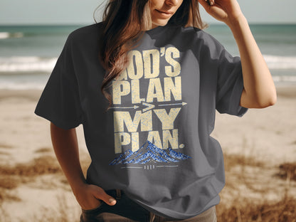 Dark grey t-shirt with "God's Plan My Plan" text and mountains graphic.