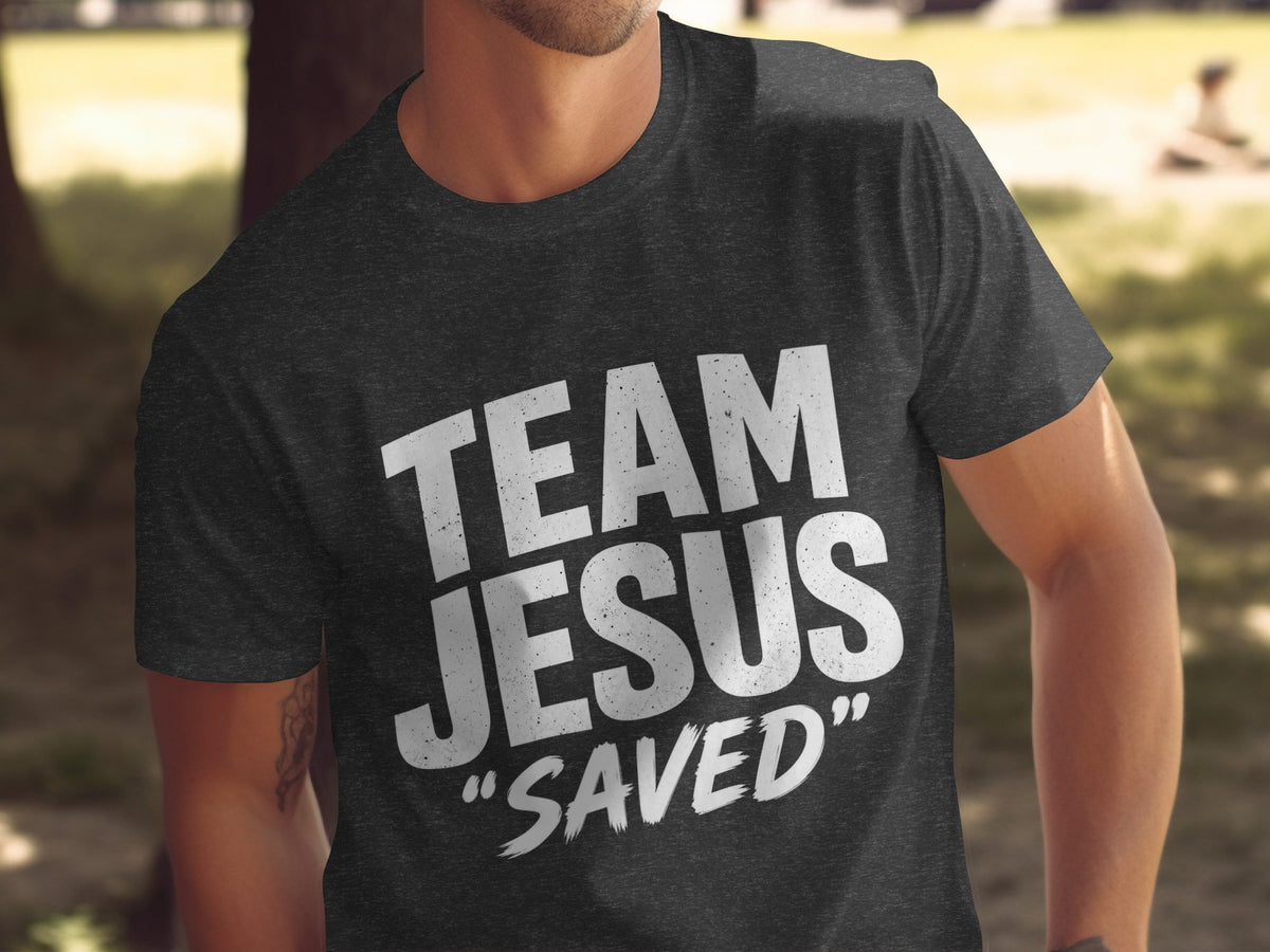 Dark grey t-shirt with "TEAM JESUS SAVED" text in distressed white lettering.