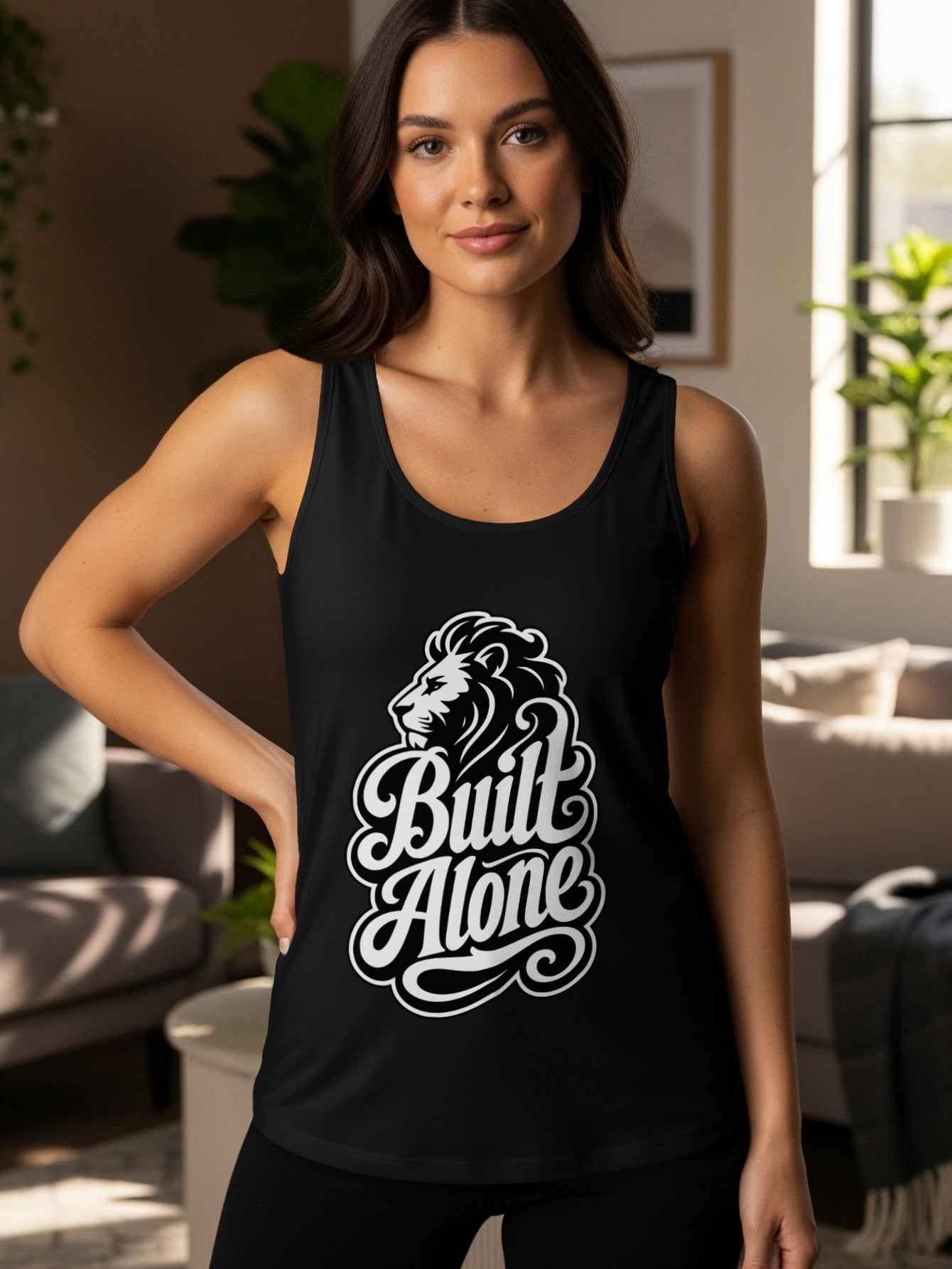 Black tank top with white lion graphic and text "Built Alone".