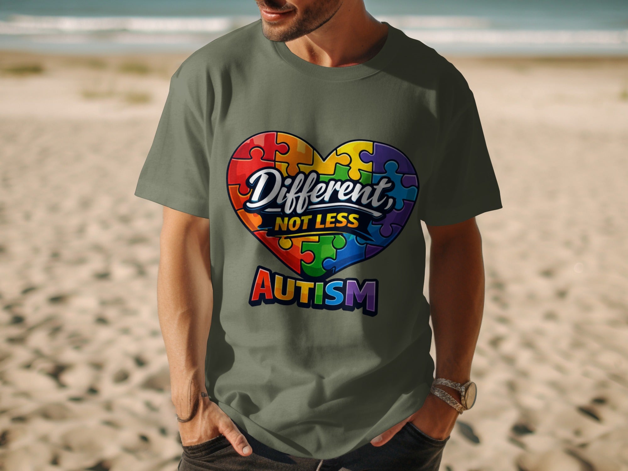 Green t-shirt with a heart made of rainbow puzzle pieces saying "Different, NOT LESS Autism".