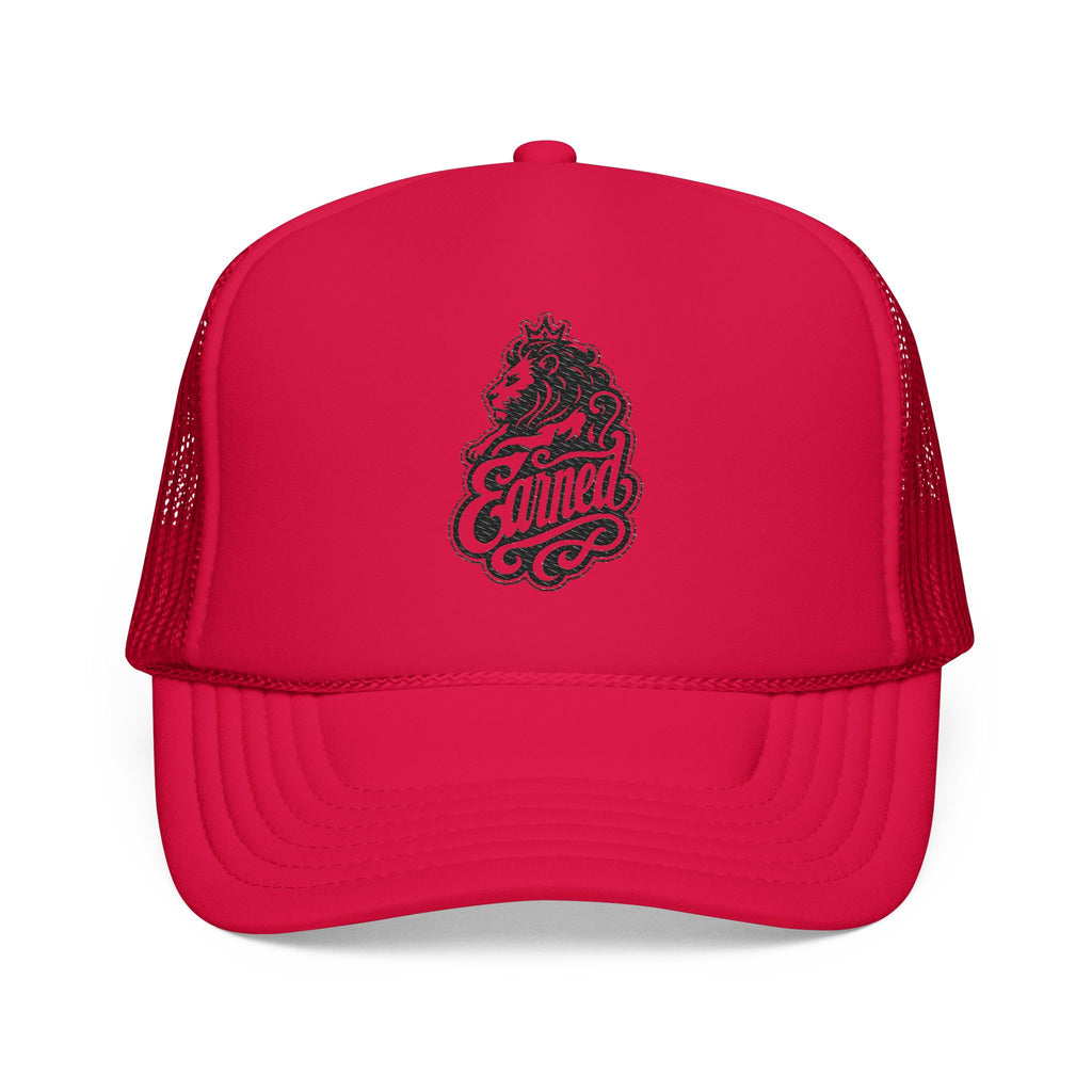 Red trucker hat with a lion wearing a crown and the word "Earned".
