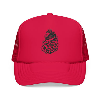 Red trucker hat with a lion wearing a crown and the word "Earned".