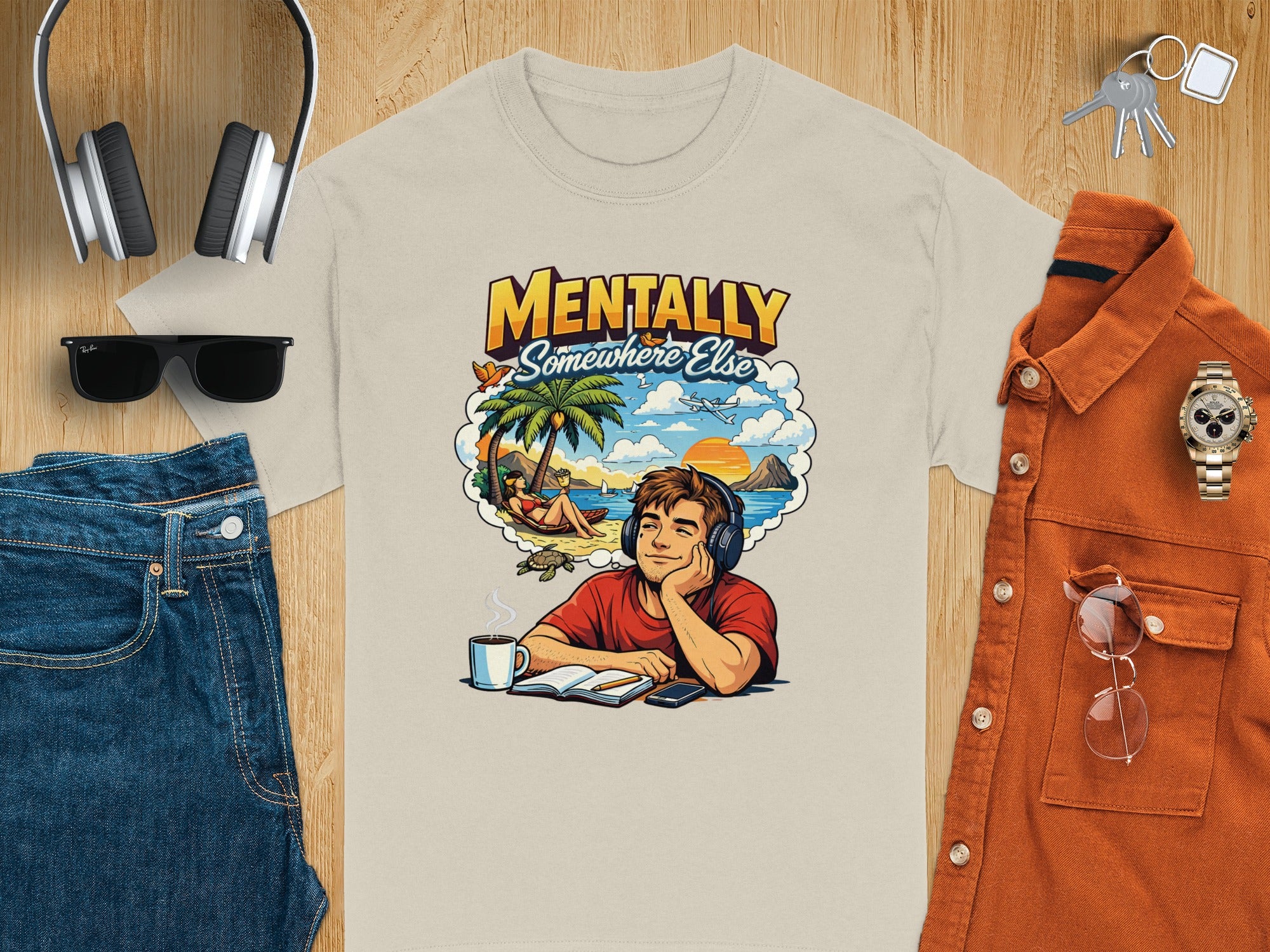 T-shirt with "Mentally Somewhere Else" graphic of a daydreaming person on a beach.