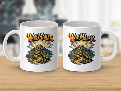 White mugs with "Way Maker" text and mountain pathway artwork.