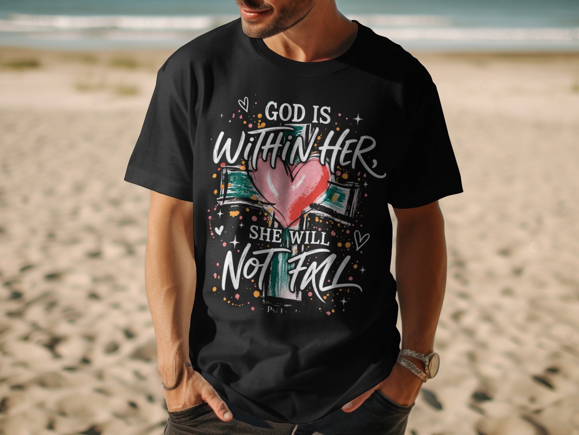 Black t-shirt with "God is Within Her She Will Not Fall" text and a heart on a cross.