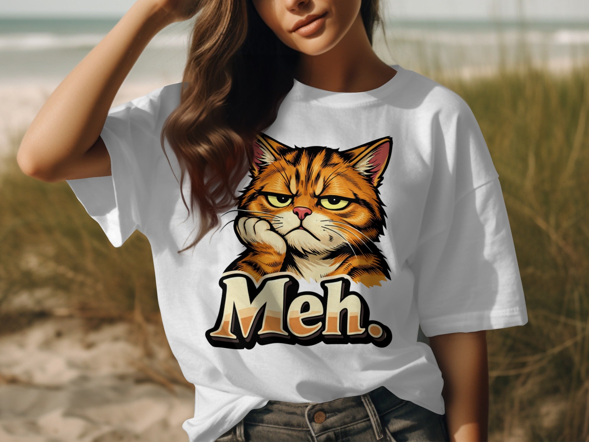 White t-shirt with cartoon grumpy orange cat and text "Meh"