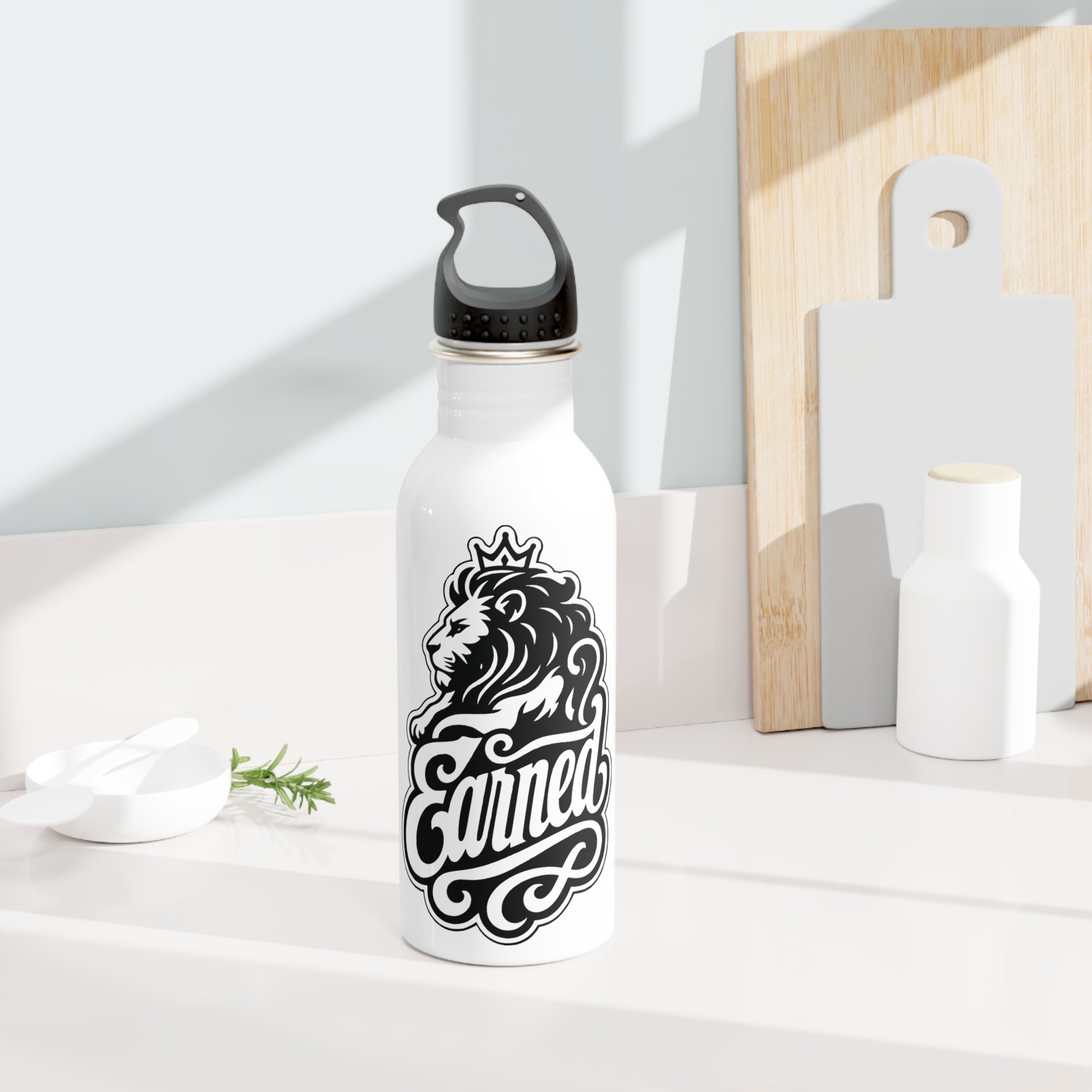 White water bottle with black lion and crown logo and the word "Earned".