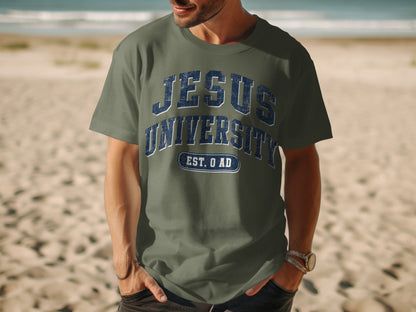 Green t-shirt with "JESUS UNIVERSITY EST. 0 AD" text on beach background