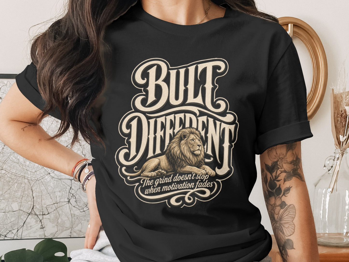 Black t-shirt with lion graphic and text "BULT DIFFERENT" and "The grind doesn't stop".