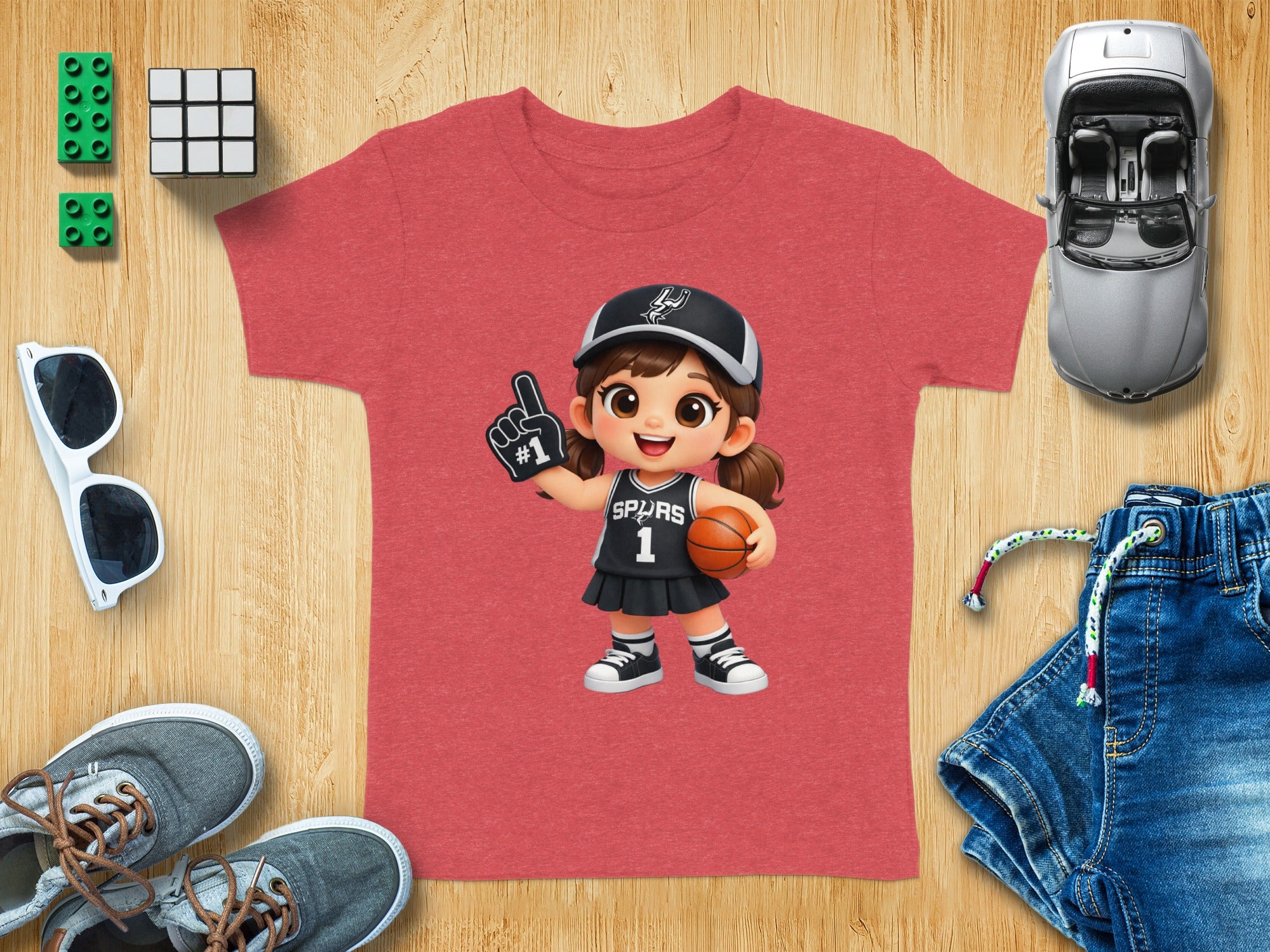 Red t-shirt with cartoon girl in Spurs jersey holding a basketball.