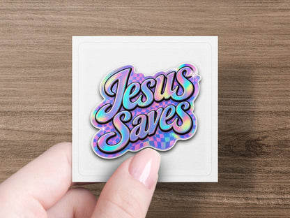 Holographic sticker with "Jesus Saves" in cursive on a checkered background.
