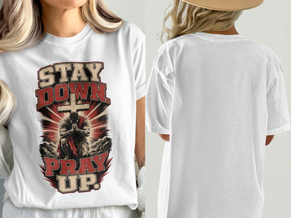 White t-shirt with "Stay Down Pray Up" graphic featuring kneeling figure and cross.