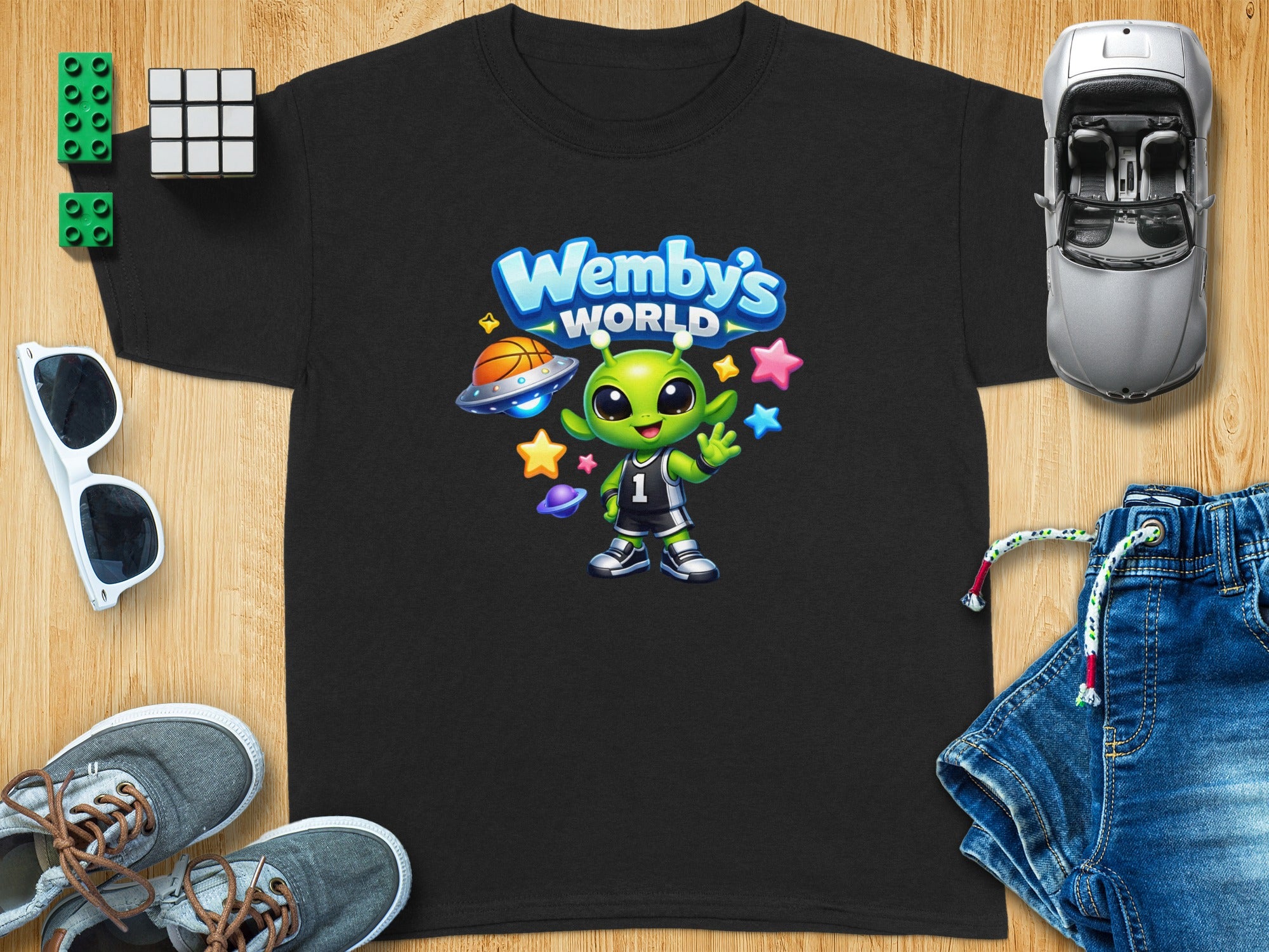 Black t-shirt with cartoon alien and "Wemby's World" text.