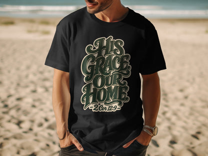 Black t-shirt with green text "His Grace Our Home - 2 Cor 12:9" on a beach