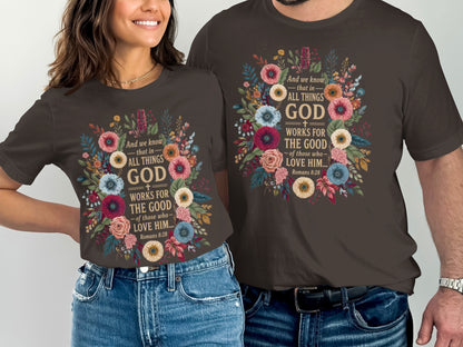 Dark brown t-shirts featuring floral designs and the scripture "All Things God Works for the Good".