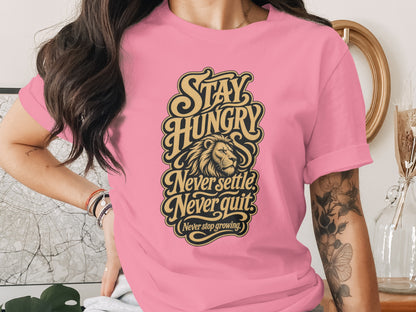 Pink t-shirt with "Stay Hungry," "Never Settle," "Never Quit," and "Never Stop Growing" text and lion graphic.