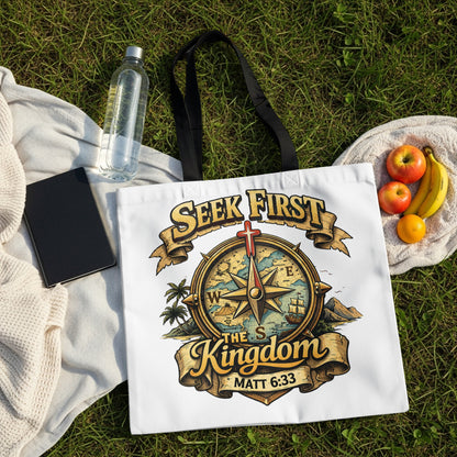 White tote bag with "Seek First The Kingdom" and compass design.