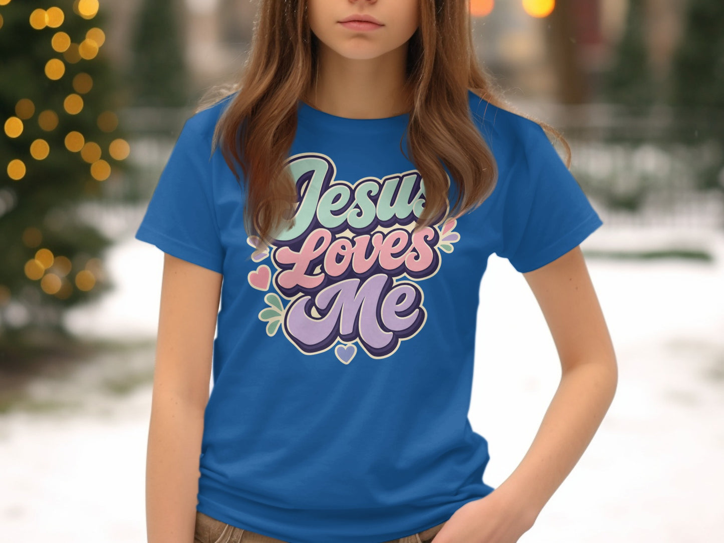 Blue t-shirt with "Jesus Loves Me" in colorful retro lettering and hearts.