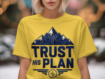 Yellow t-shirt with blue mountains, a cross, and "TRUST HIS PLAN" text.