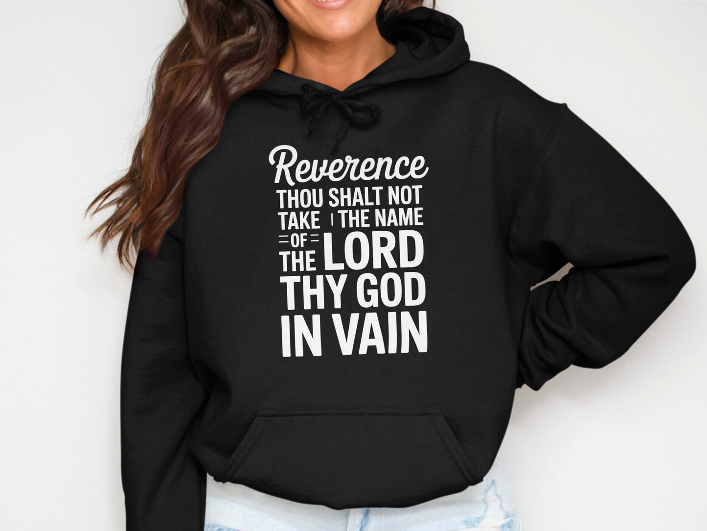 Black hoodie with white text: Reverence Thou Shalt Not Take the Name of the Lord Thy God In Vain.