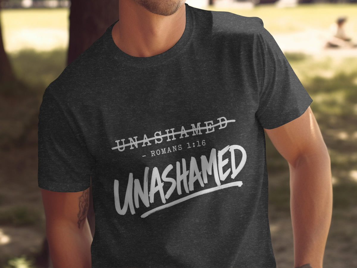 Dark grey t-shirt with white text "UNASHAMED" and "ROMANS 1:16".