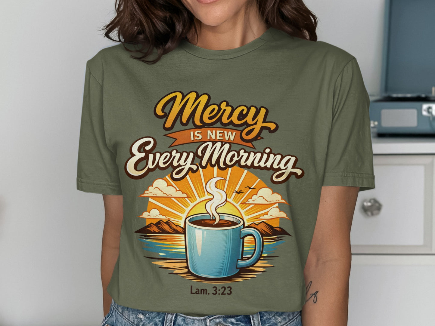 Green t-shirt with "Mercy Is New Every Morning Lam. 3:23" and sunrise coffee graphic.
