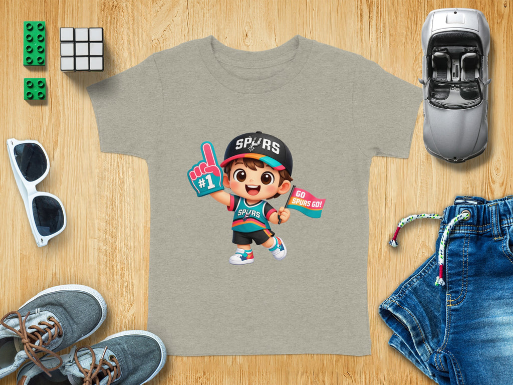 T-shirt with cartoon child wearing Spurs hat and jersey, holding foam finger and flag.
