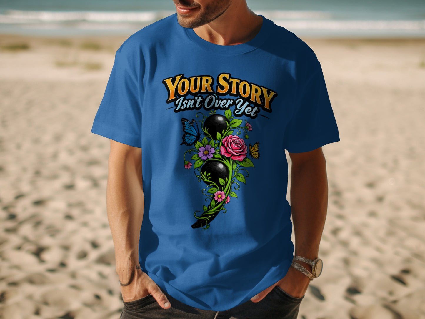 Blue shirt with slogan "Your Story Isn't Over Yet" and semicolon design.
