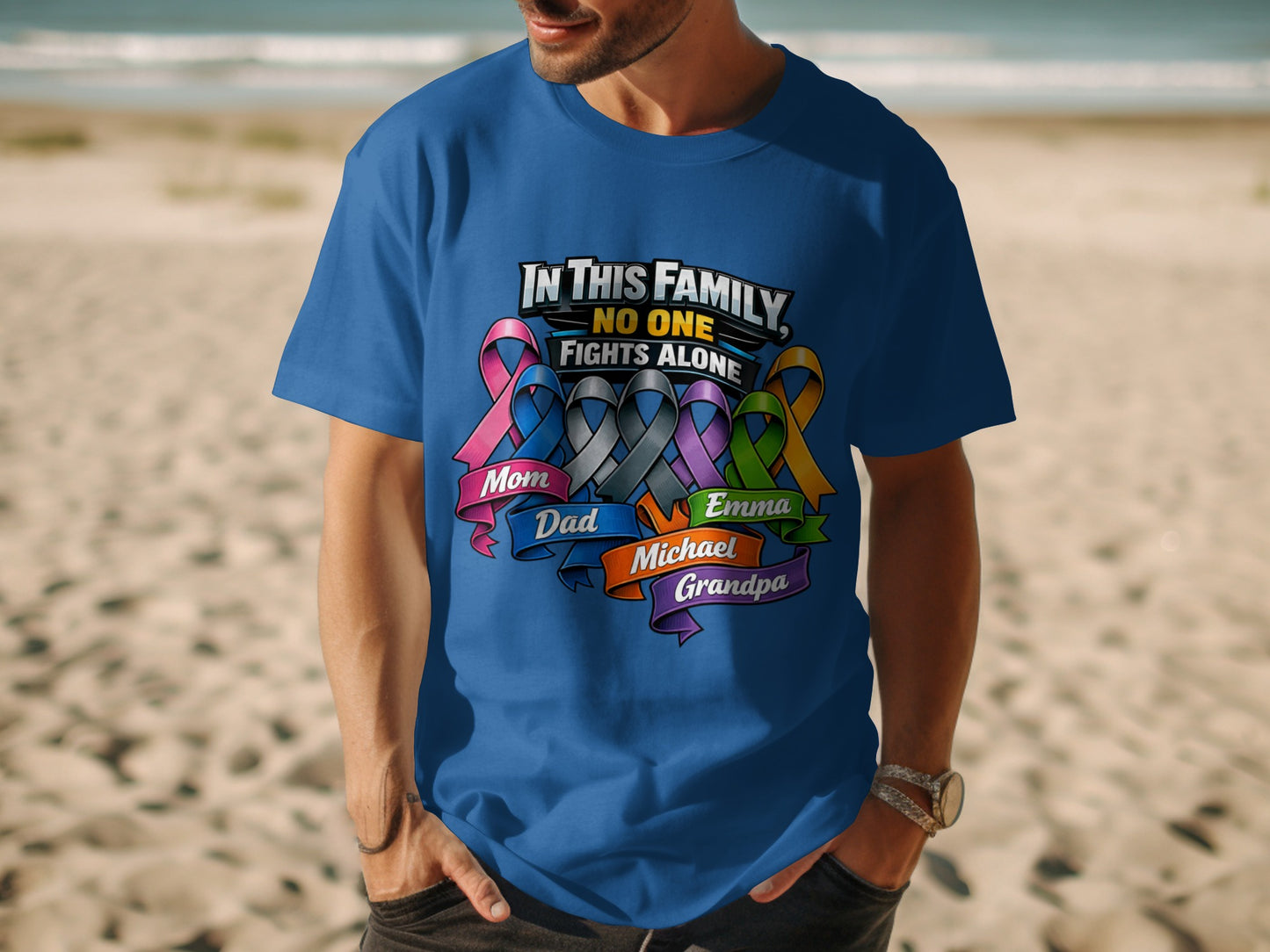 Blue t-shirt with "In This Family, No One Fights Alone" and family names.