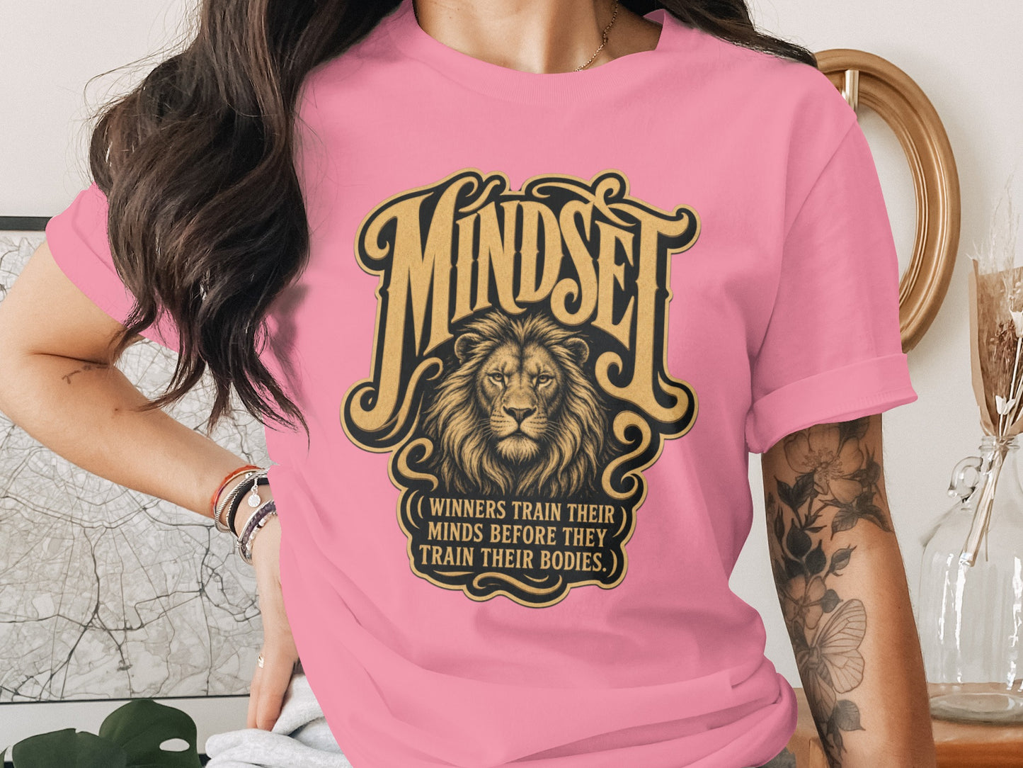 Pink t-shirt with "Mindset" graphic and lion, featuring quote.