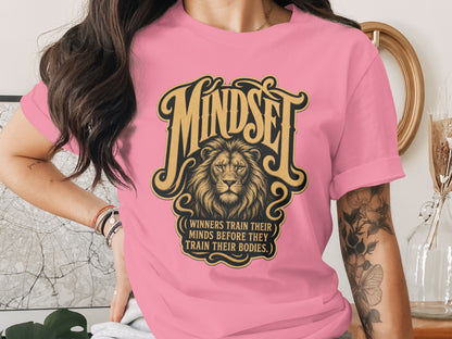 Pink t-shirt with "Mindset" graphic and lion, featuring quote.