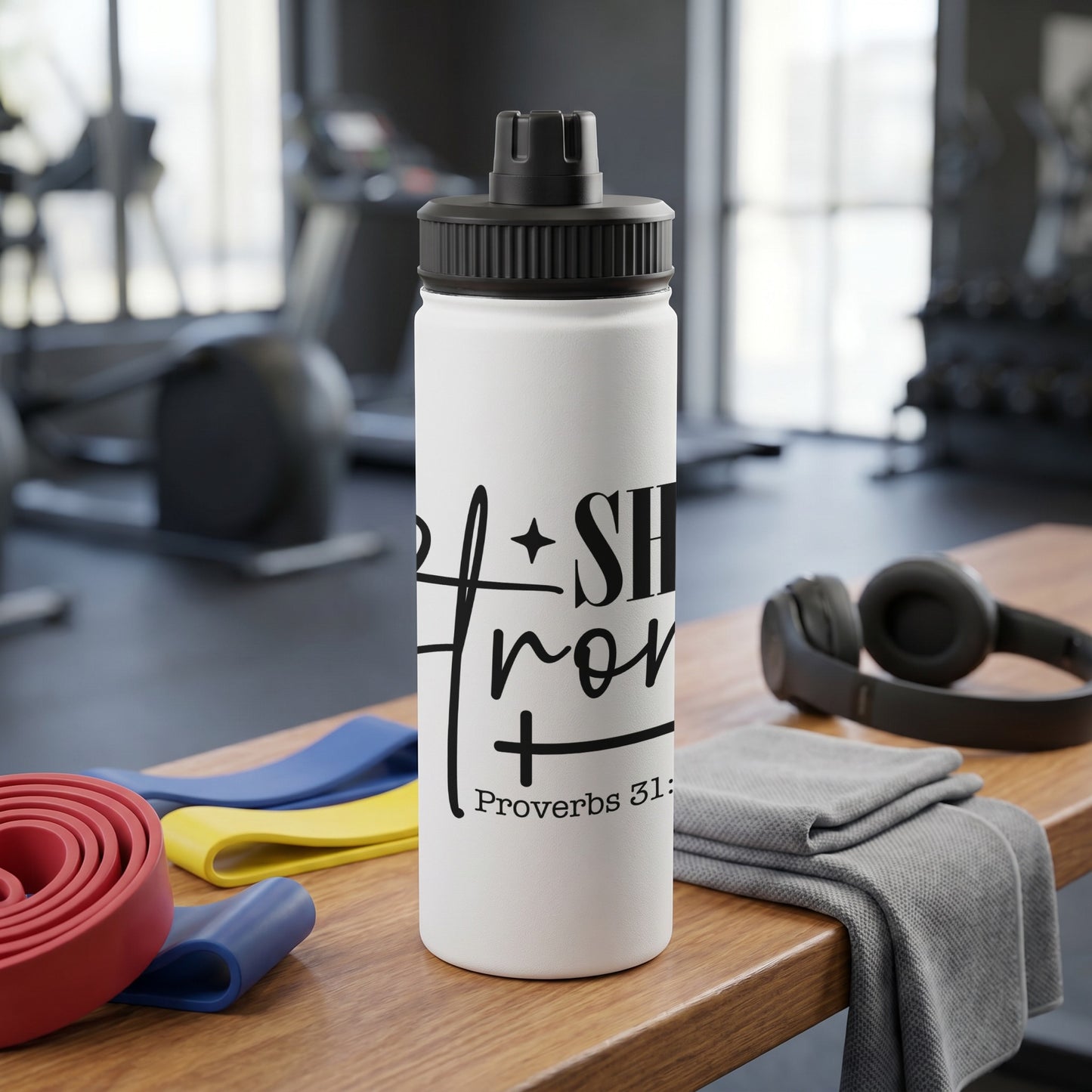 White water bottle with black text: "She is clothed in strength and dignity" Proverbs 31:25.
