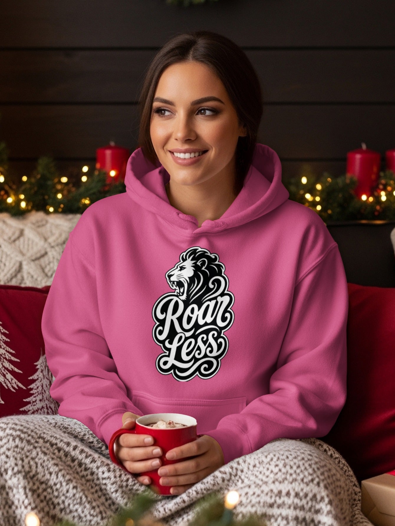 Pink hoodie with lion graphic and "Roar Less" text.