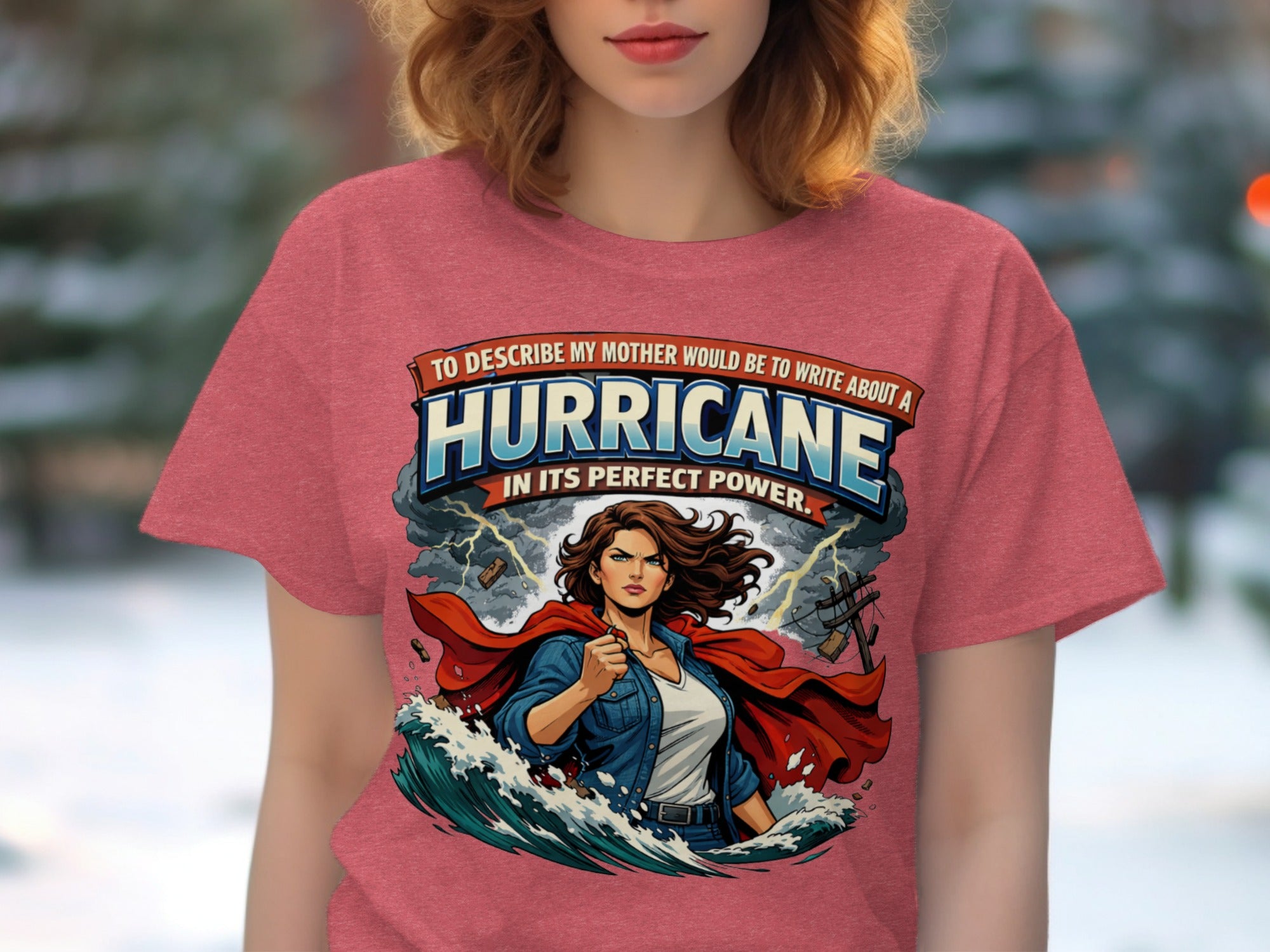 Graphic t-shirt with text about a mother and a hurricane with a cape-wearing woman.