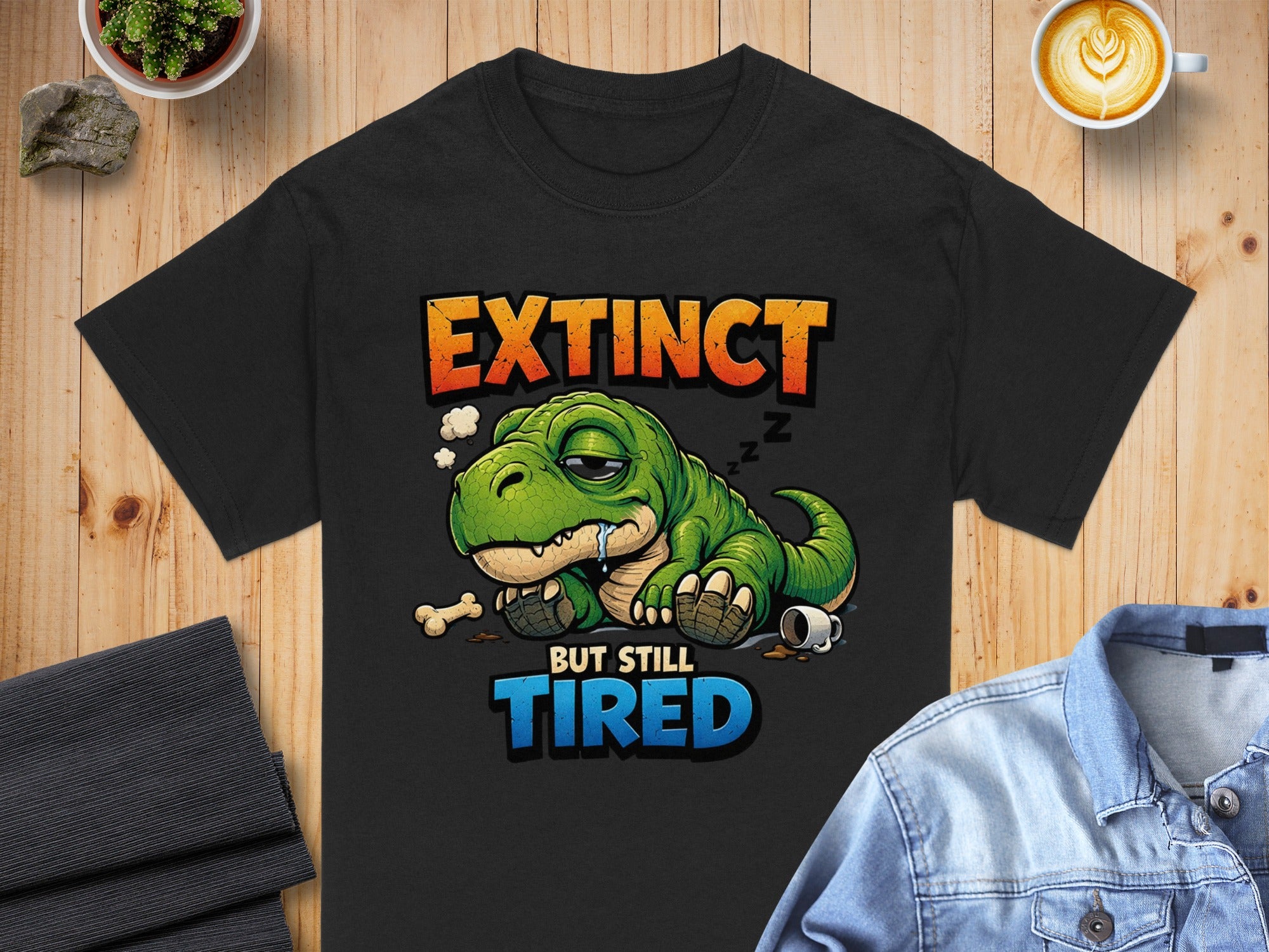 Black t-shirt with sleeping T-Rex graphic and text "Extinct But Still Tired".