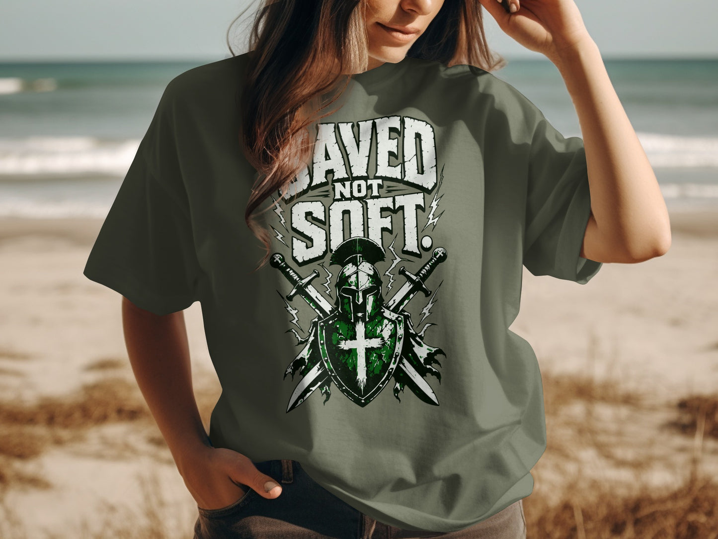T-shirt with text "SAVED NOT SOFT", knight helmet, shield, and crossed swords.