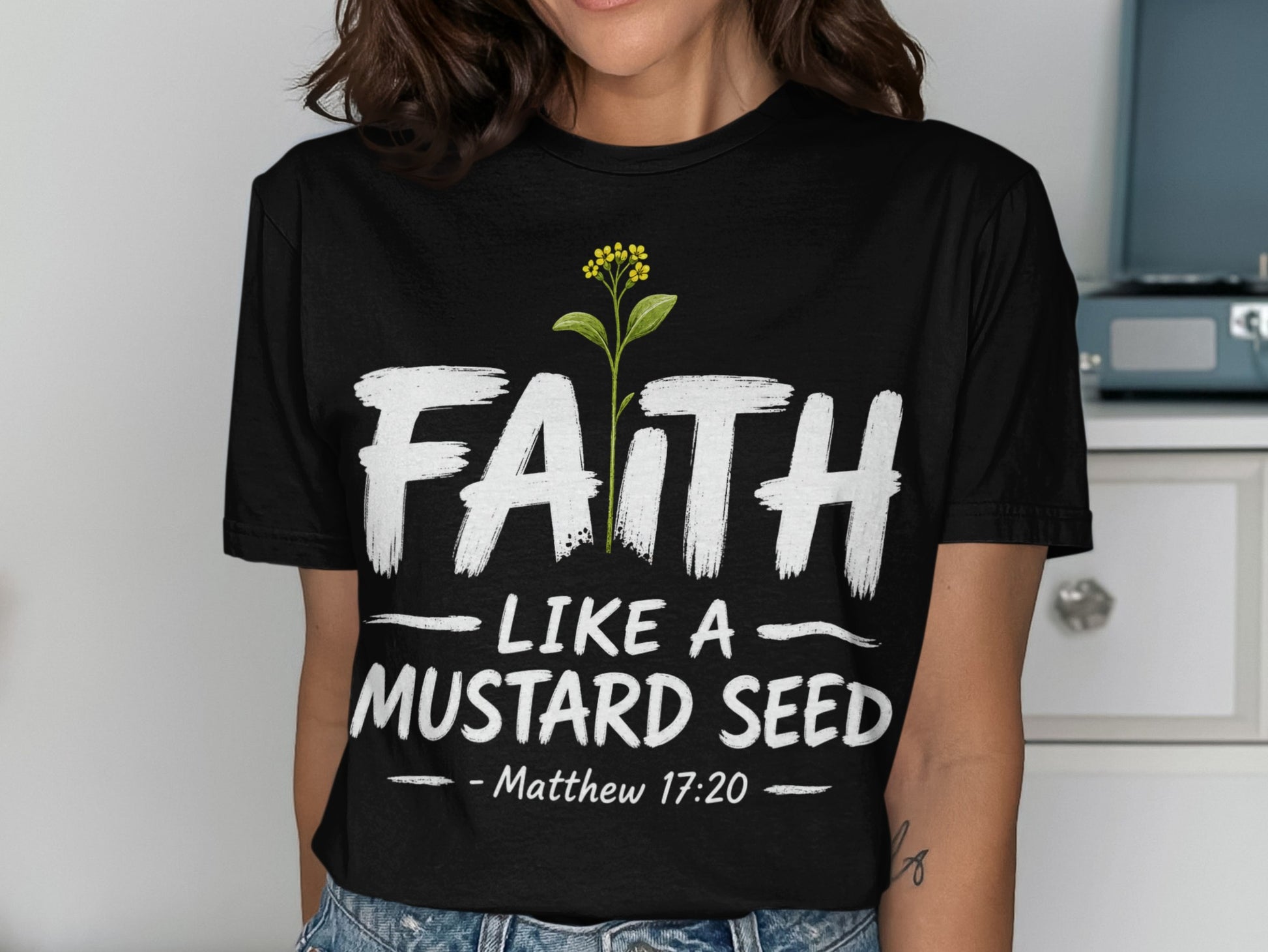 Black t-shirt with text "FAITH LIKE A MUSTARD SEED Matthew 17:20" and a plant.