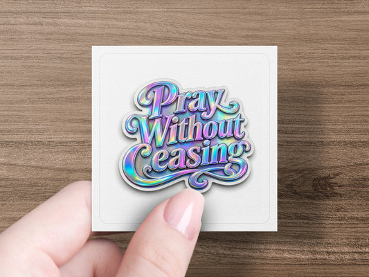 Holographic sticker with "Pray Without Ceasing" text held by fingers