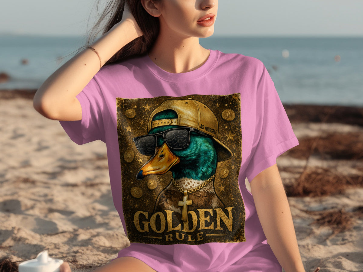 Pink t-shirt with duck graphic featuring sunglasses, gold chain, and "GOLDEN RULE" text.