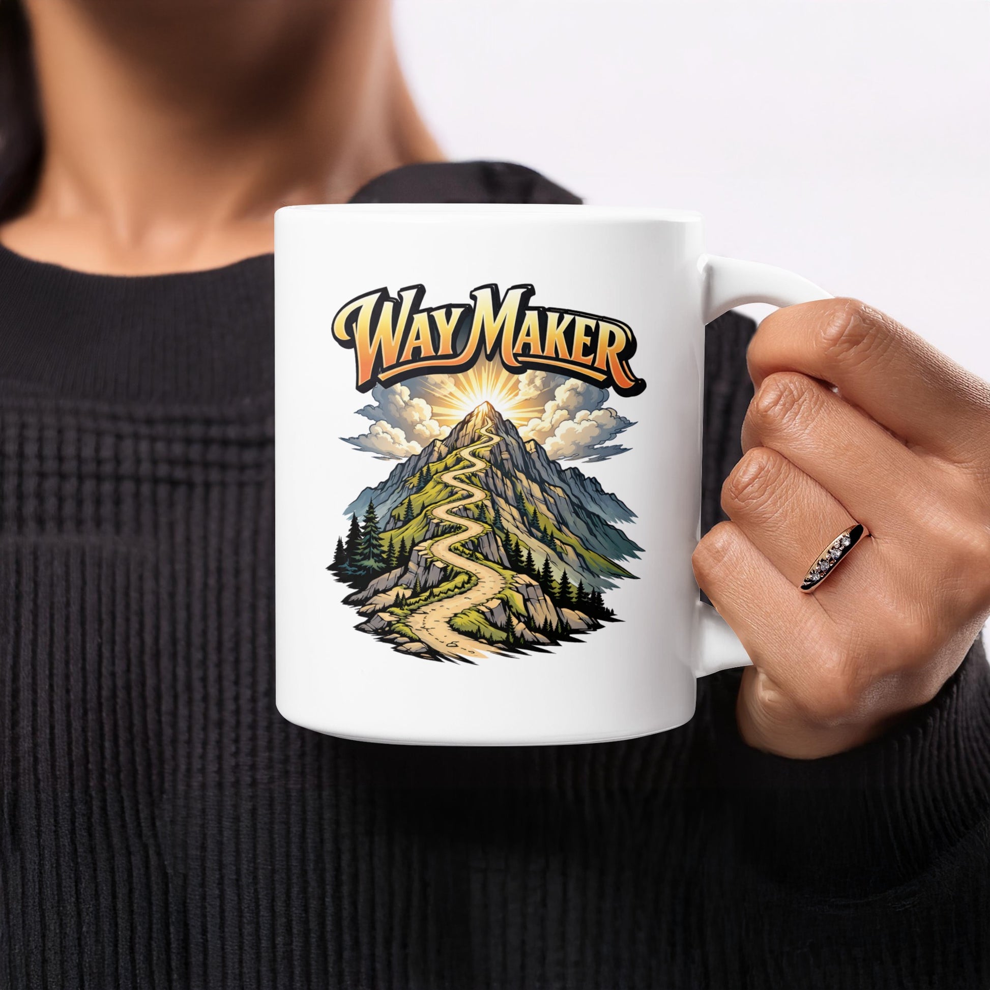 White mug with graphic of winding road up a mountain with "Way Maker" text.