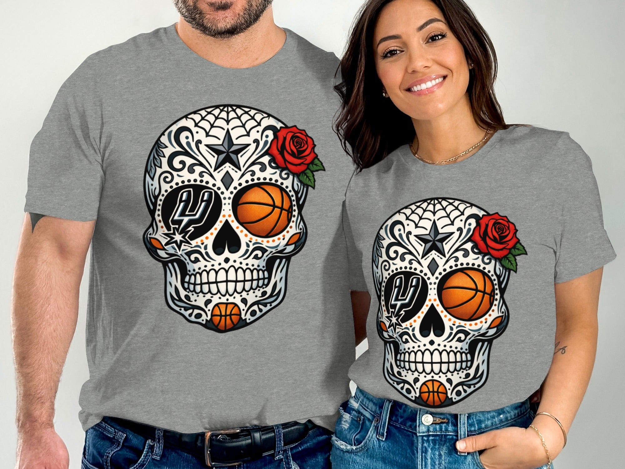 Two people wear gray t-shirts featuring a sugar skull with roses and basketballs.
