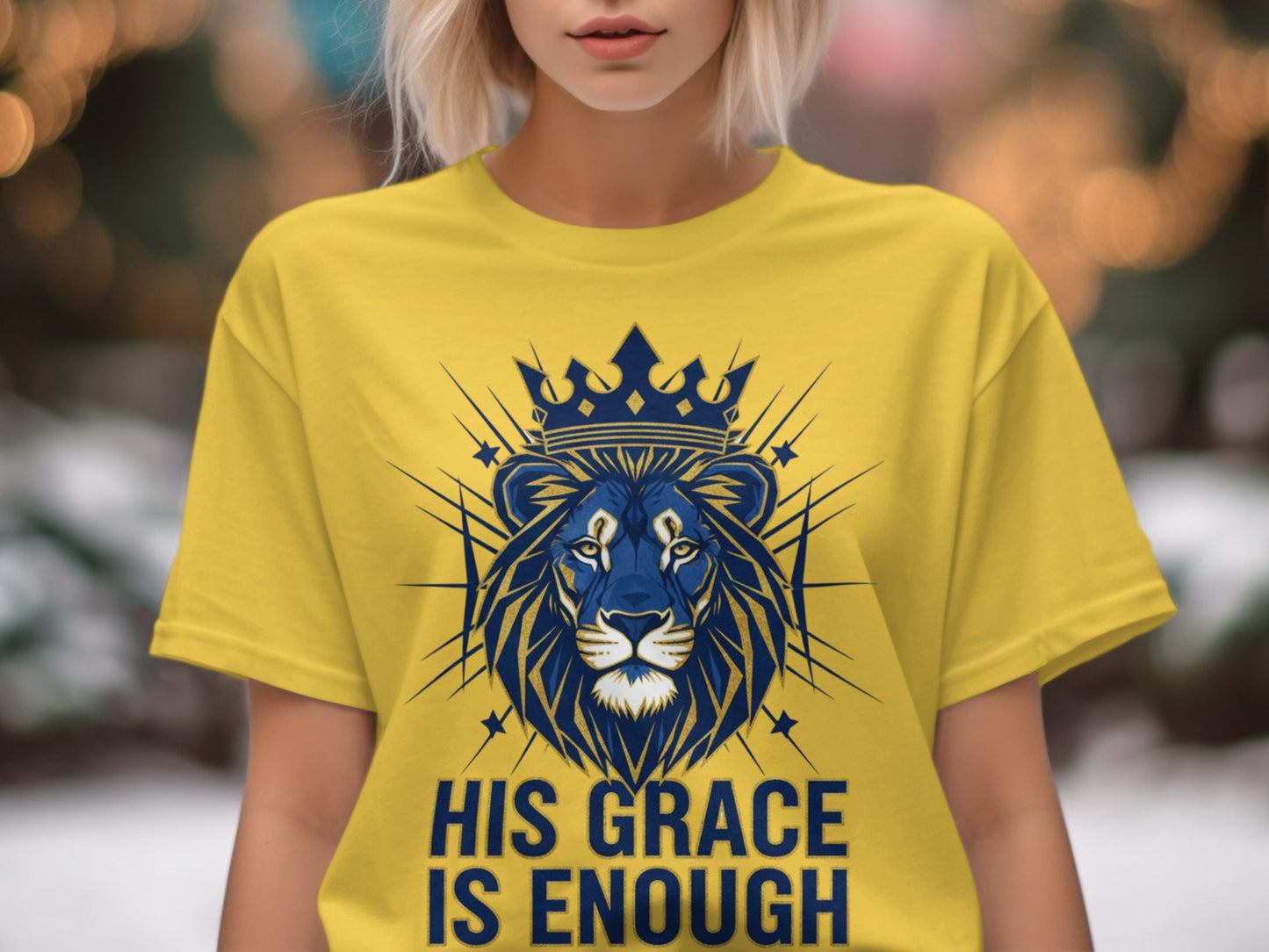 Yellow t-shirt with a blue lion and crown design, text "HIS GRACE IS ENOUGH".