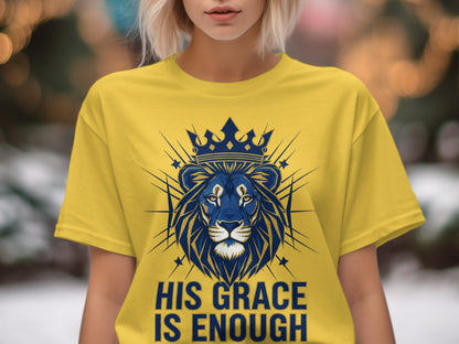 Yellow t-shirt with a blue lion and crown design, text "HIS GRACE IS ENOUGH".