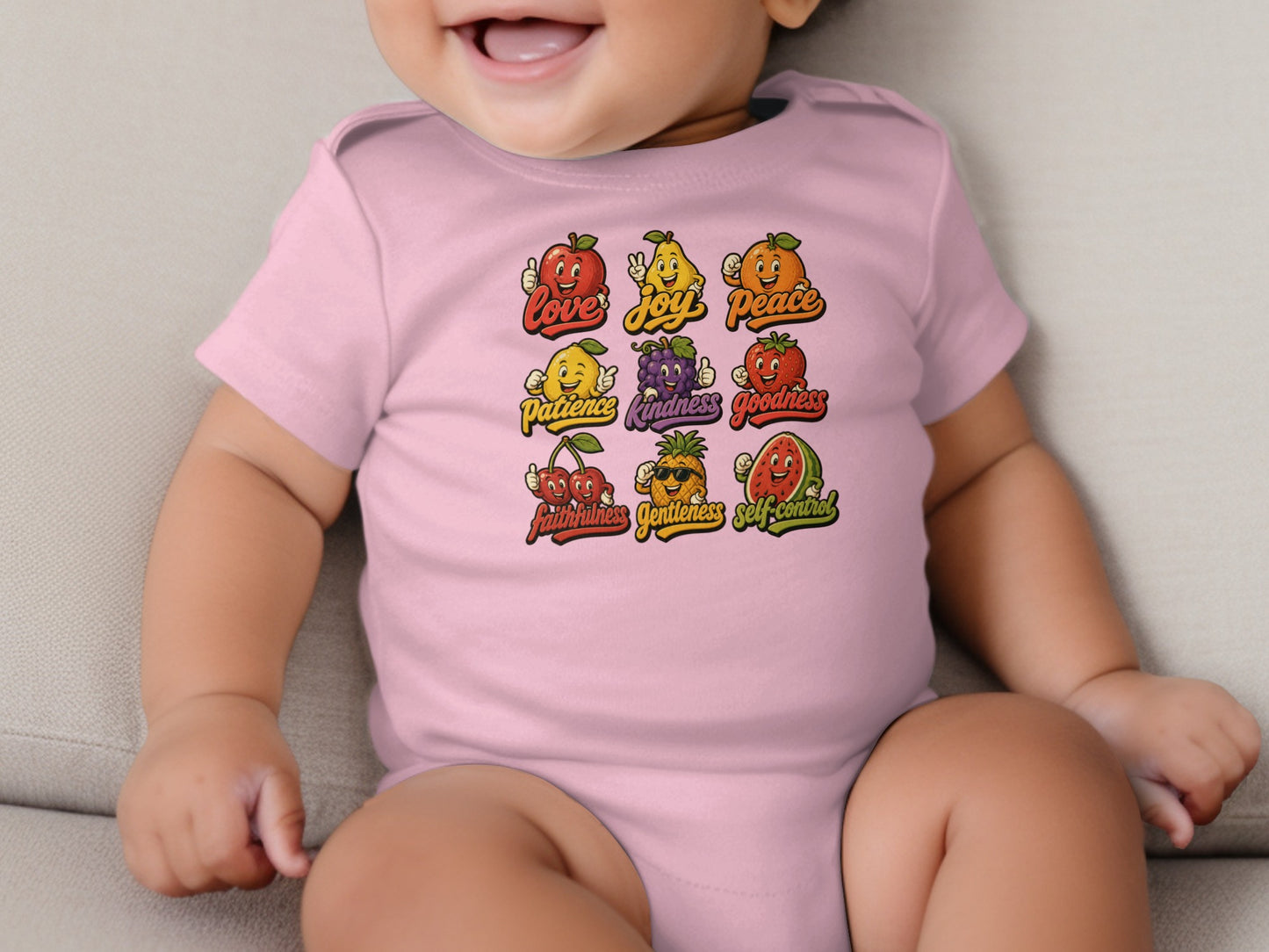 Pink baby bodysuit with a nine-panel fruit illustration and text.
